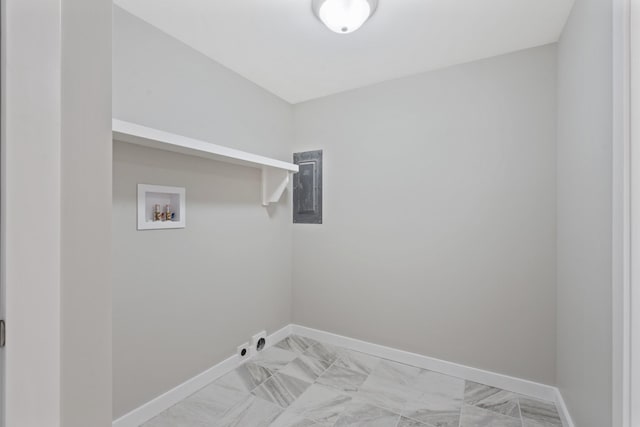 clothes washing area with electric panel, washer hookup, laundry area, marble finish floor, and baseboards