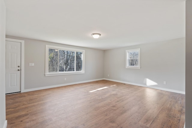 unfurnished room featuring wood finished floors and baseboards