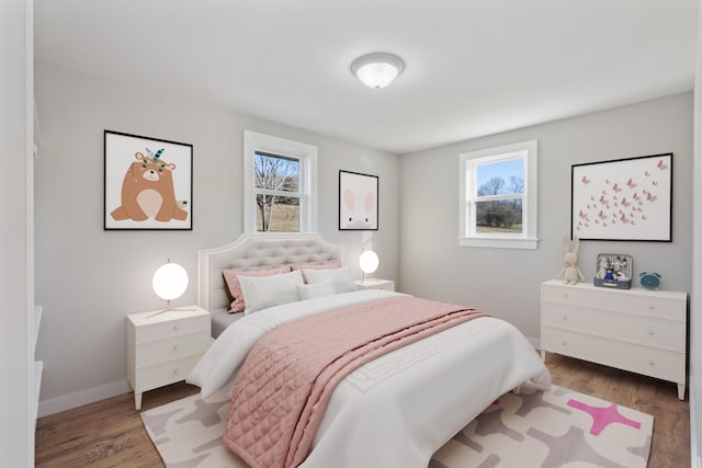 bedroom with wood finished floors and baseboards