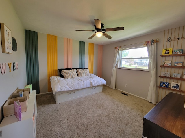 carpeted bedroom featuring visible vents, a ceiling fan, and baseboards