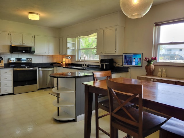 kitchen featuring a sink, appliances with stainless steel finishes, open shelves, and white cabinetry