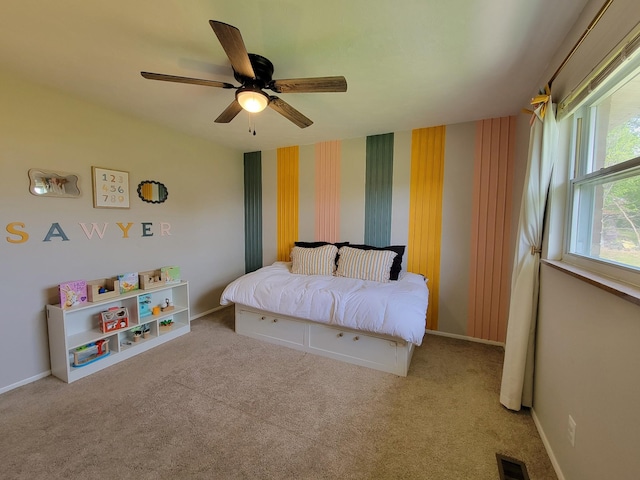 bedroom with ceiling fan, visible vents, baseboards, and carpet