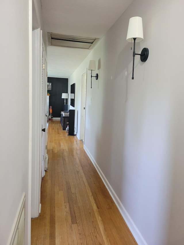 hallway featuring light wood finished floors and visible vents