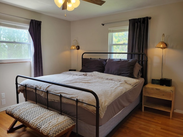 bedroom featuring baseboards and wood finished floors