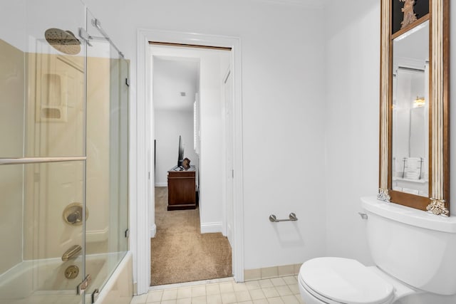 full bath with toilet, tile patterned flooring, enclosed tub / shower combo, and baseboards