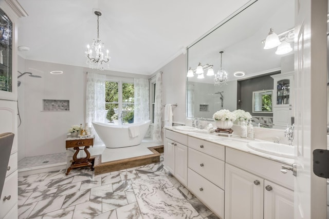 full bath featuring a sink, marble finish floor, an inviting chandelier, and walk in shower