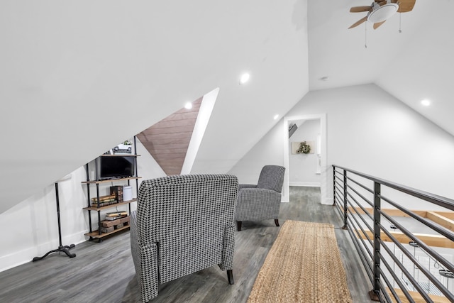 interior space with ceiling fan, wood finished floors, and lofted ceiling