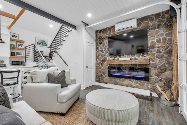 living area featuring a wall unit AC, a fireplace, stairs, wood ceiling, and wood finished floors