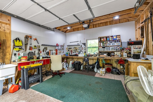 garage featuring a garage door opener and a workshop area