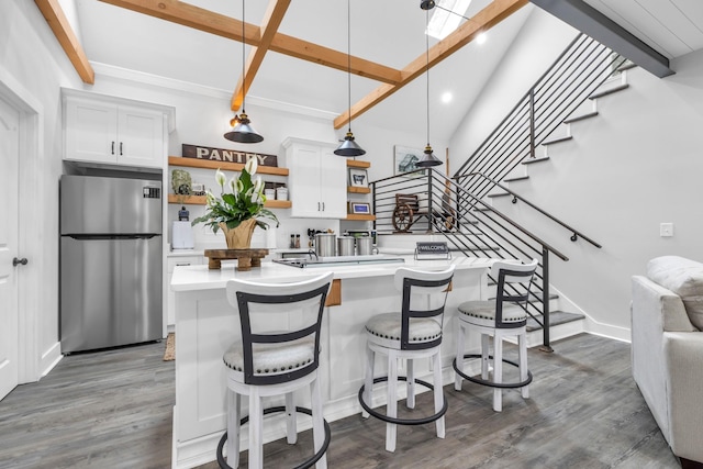 kitchen with white cabinetry, open shelves, light countertops, and freestanding refrigerator