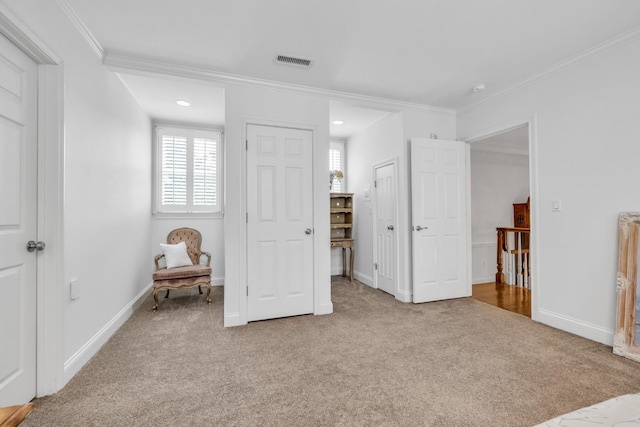 carpeted bedroom featuring ornamental molding, visible vents, and baseboards
