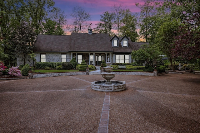 cape cod house with a shingled roof
