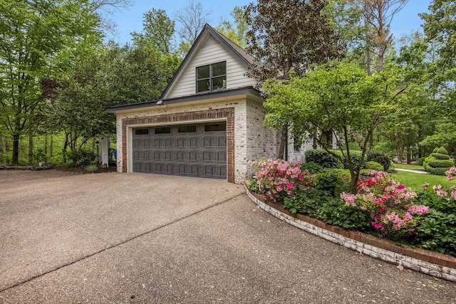 garage featuring concrete driveway