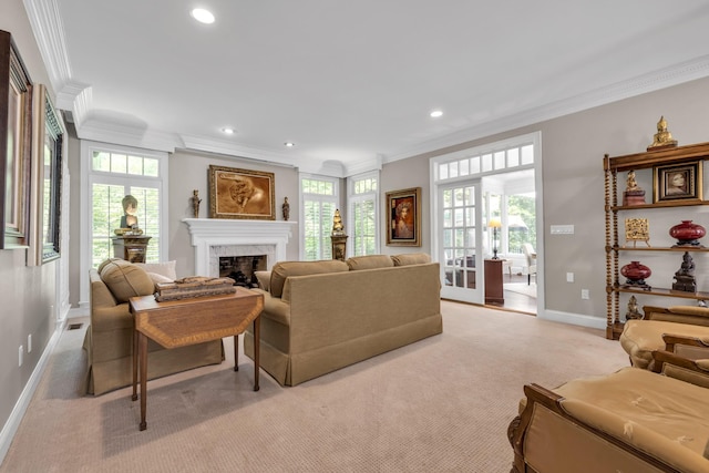 living room featuring a healthy amount of sunlight, light colored carpet, ornamental molding, a fireplace, and baseboards
