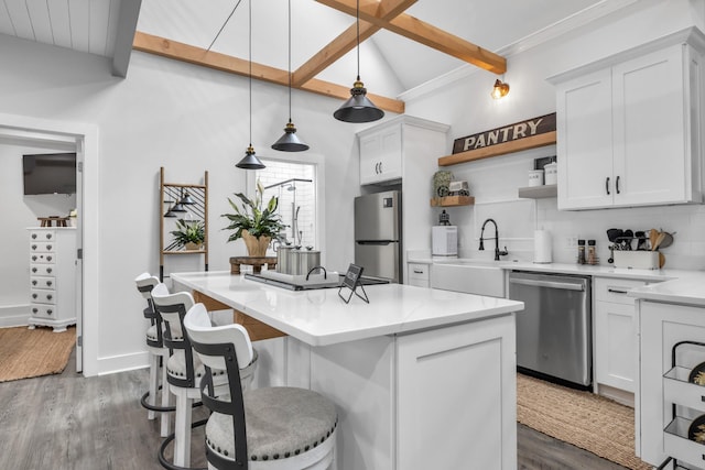 kitchen with open shelves, appliances with stainless steel finishes, backsplash, a sink, and dark wood-type flooring