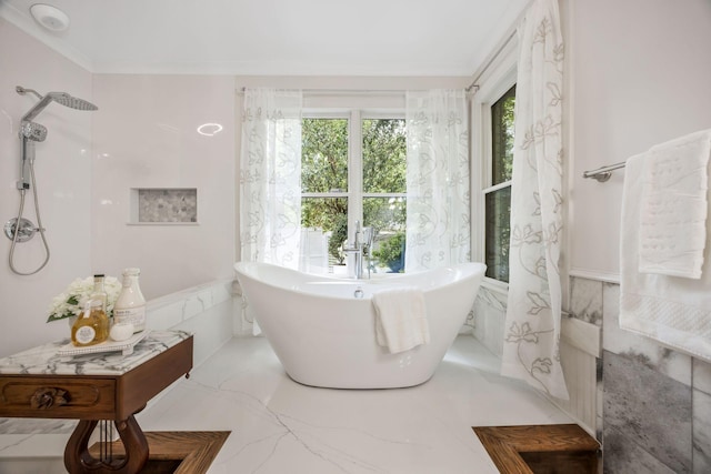 full bath featuring a freestanding tub, a wainscoted wall, marble finish floor, a shower, and ornamental molding
