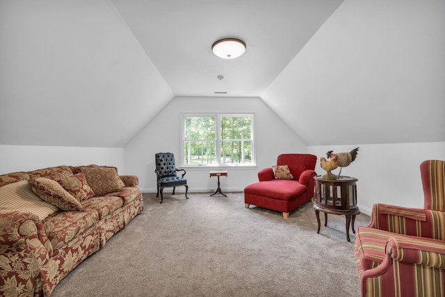 carpeted living room featuring baseboards and lofted ceiling