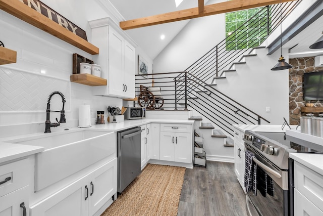 kitchen with white cabinetry, open shelves, a sink, appliances with stainless steel finishes, and dark wood-style floors