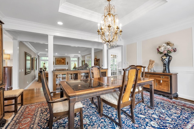 dining space with crown molding, recessed lighting, a notable chandelier, and wood finished floors