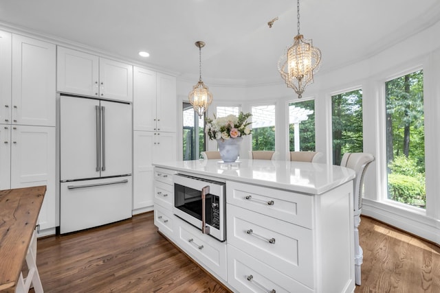 kitchen with white cabinetry, white appliances, plenty of natural light, and a notable chandelier