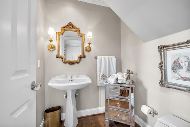 bathroom featuring toilet, wood finished floors, and baseboards