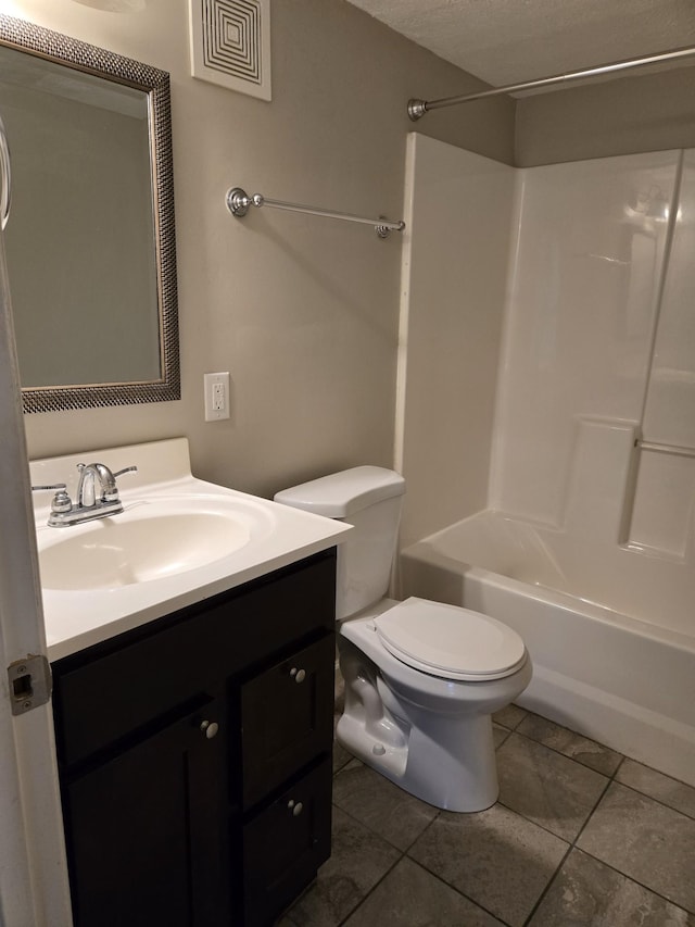 bathroom with shower / tub combination, toilet, vanity, and tile patterned flooring