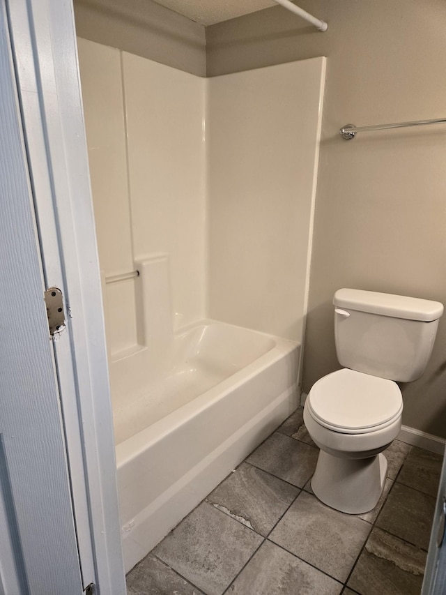 full bathroom with bathing tub / shower combination, toilet, and tile patterned flooring