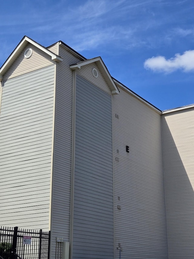 view of home's exterior with fence