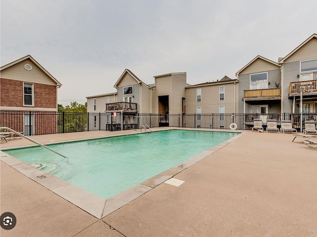 pool with fence and a patio