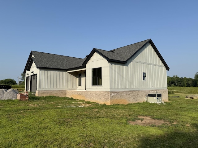 176 Beartown Rd, Loretto, TN 38469 - view of property exterior with a shingled roof, a lawn, cooling unit, and board and batten siding