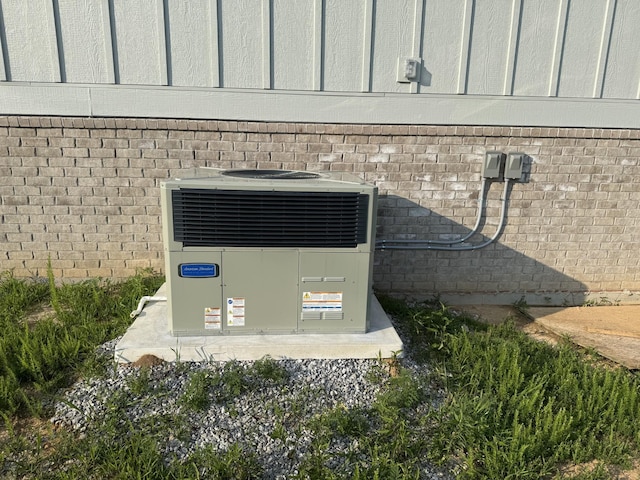 176 Beartown Rd, Loretto, TN 38469 - exterior view of central AC unit, brick siding, and board and batten siding