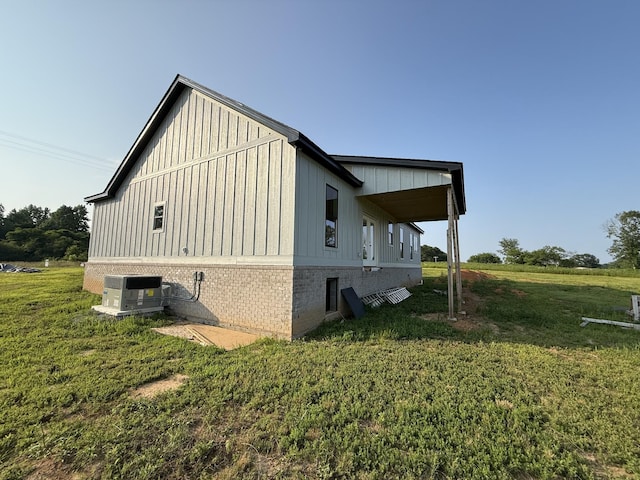 176 Beartown Rd, Loretto, TN 38469 - view of property exterior with a lawn, central AC unit, board and batten siding, and brick siding