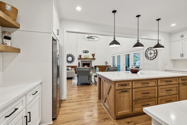 kitchen featuring recessed lighting, light countertops, and a fireplace