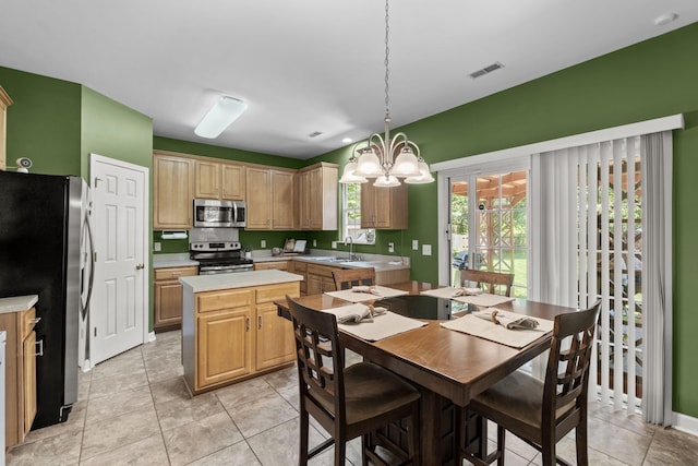 1320 Autumn Springs Ln, Old Hickory, TN 37138 - kitchen with stainless steel appliances, a sink, light countertops, a chandelier, and a center island