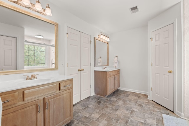 1320 Autumn Springs Ln, Old Hickory, TN 37138 - bathroom featuring two vanities, stone finish floors, a closet, and baseboards