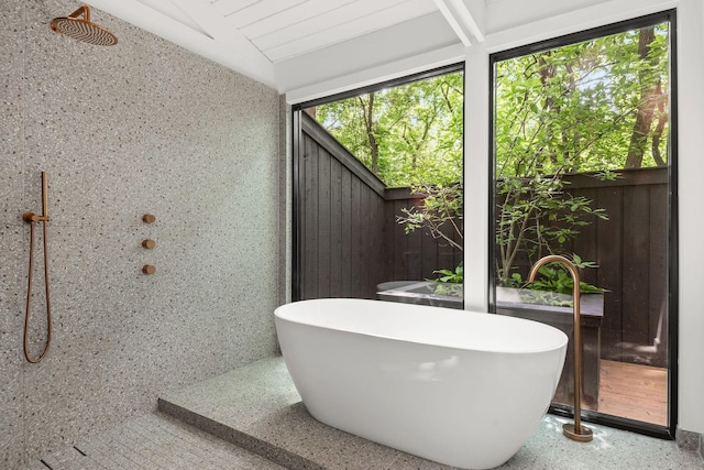 5040 Villa Crest Dr, Nashville, TN 37220 - full bathroom with speckle patterned floor, a soaking tub, and vaulted ceiling
