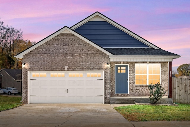 223 Casting Ct, Clarksville, TN 37043 - view of front of house featuring driveway, fence, brick siding, and a garage