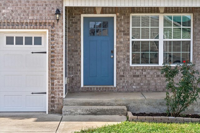 223 Casting Ct, Clarksville, TN 37043 - doorway to property with brick siding and a garage