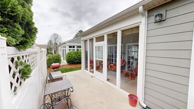 view of patio featuring a sunroom