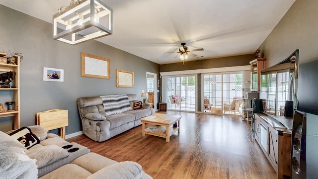 living area with ceiling fan, wood finished floors, and baseboards