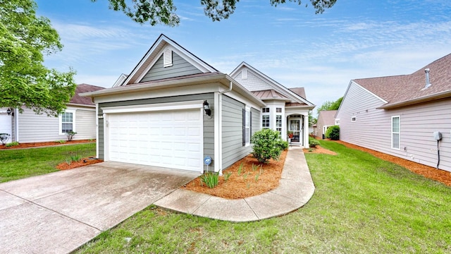 view of front of house with a front yard, driveway, and a garage