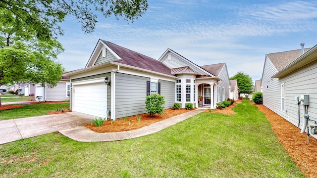 view of front facade featuring a garage, a front lawn, and driveway