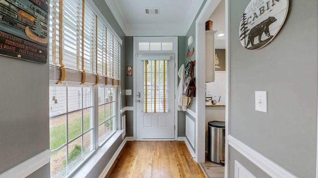 doorway to outside featuring visible vents, baseboards, and light wood-style floors