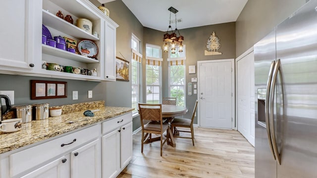 dining space featuring visible vents and light wood-style floors
