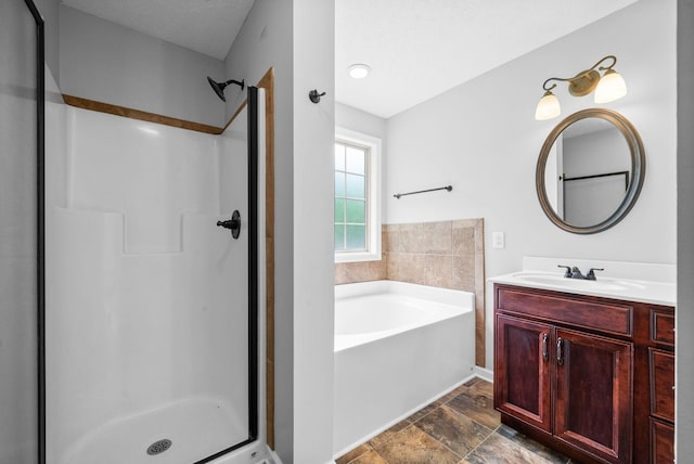 full bathroom with stone finish floor, a garden tub, vanity, and a stall shower