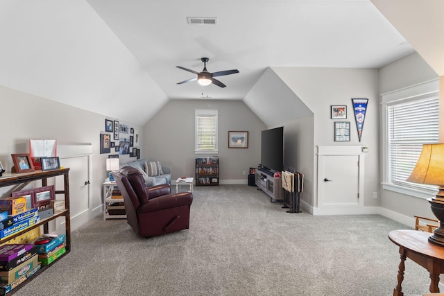 sitting room with lofted ceiling, visible vents, ceiling fan, baseboards, and carpet