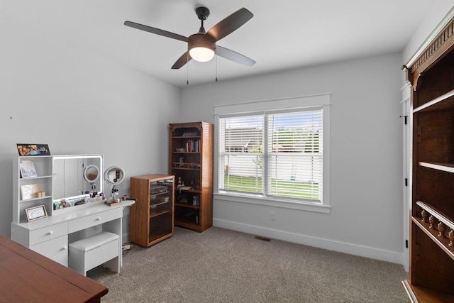 home office with baseboards, visible vents, ceiling fan, and carpet floors