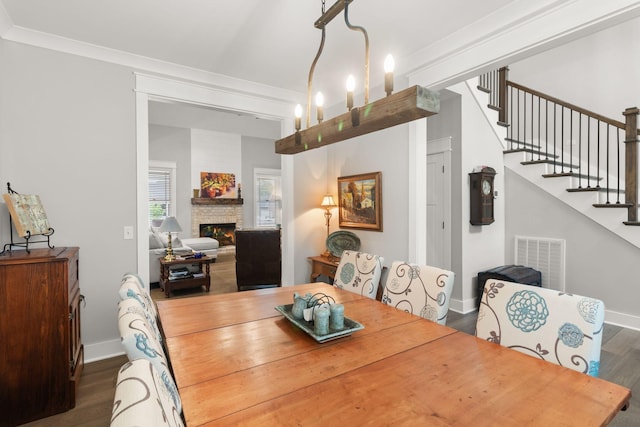 dining area with visible vents, stairway, wood finished floors, and baseboards