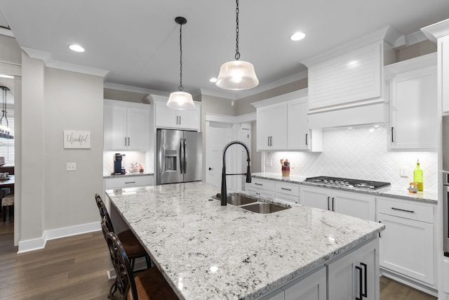 kitchen with backsplash, appliances with stainless steel finishes, crown molding, and a sink