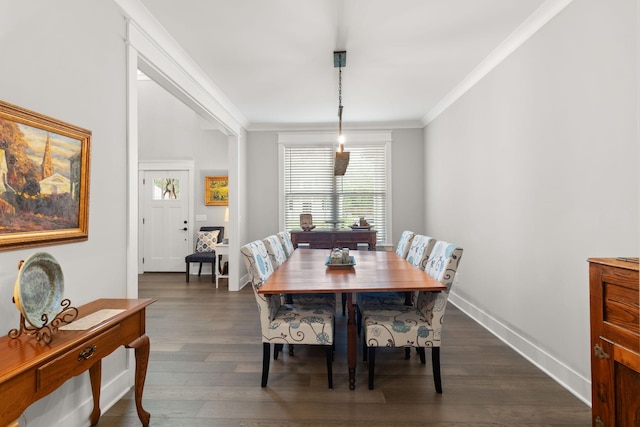 dining space with dark wood-type flooring, baseboards, and crown molding